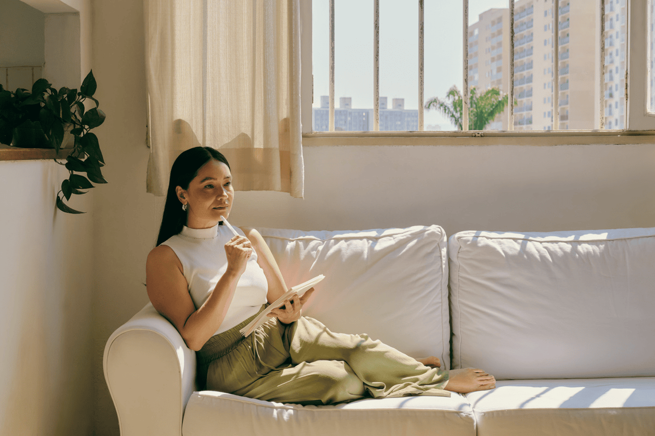 Mental Health in Recovery woman journaling on couch
